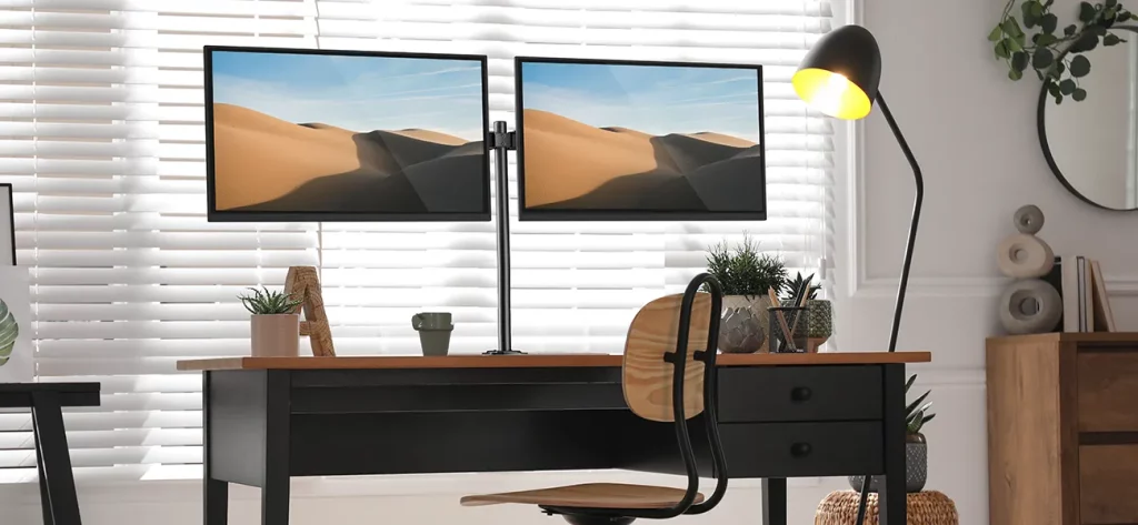 Dual arm desk mount holding monitors